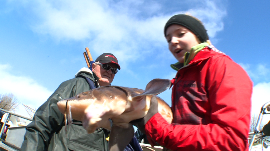 girl holding sturgeon